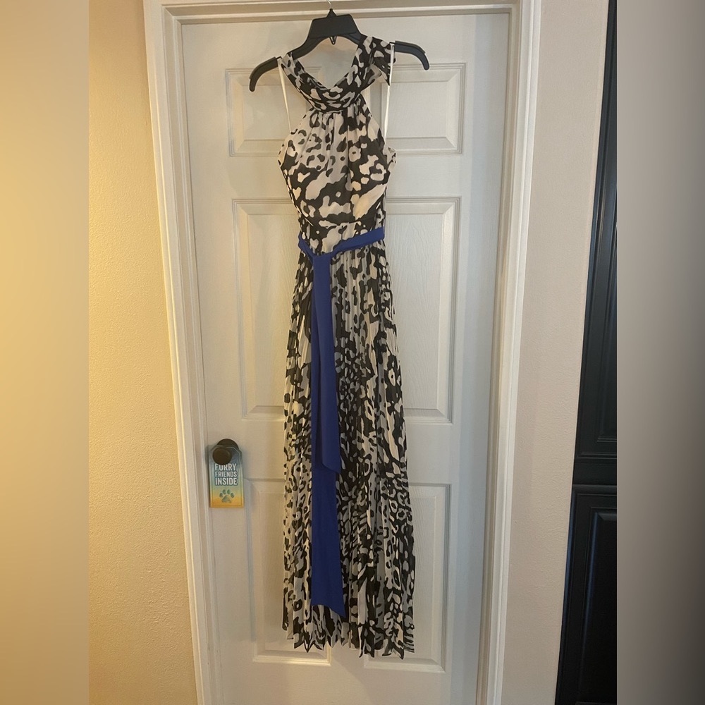 Beautiful, backless, black white with a pop of royal blue belt. Eliza J size 6.